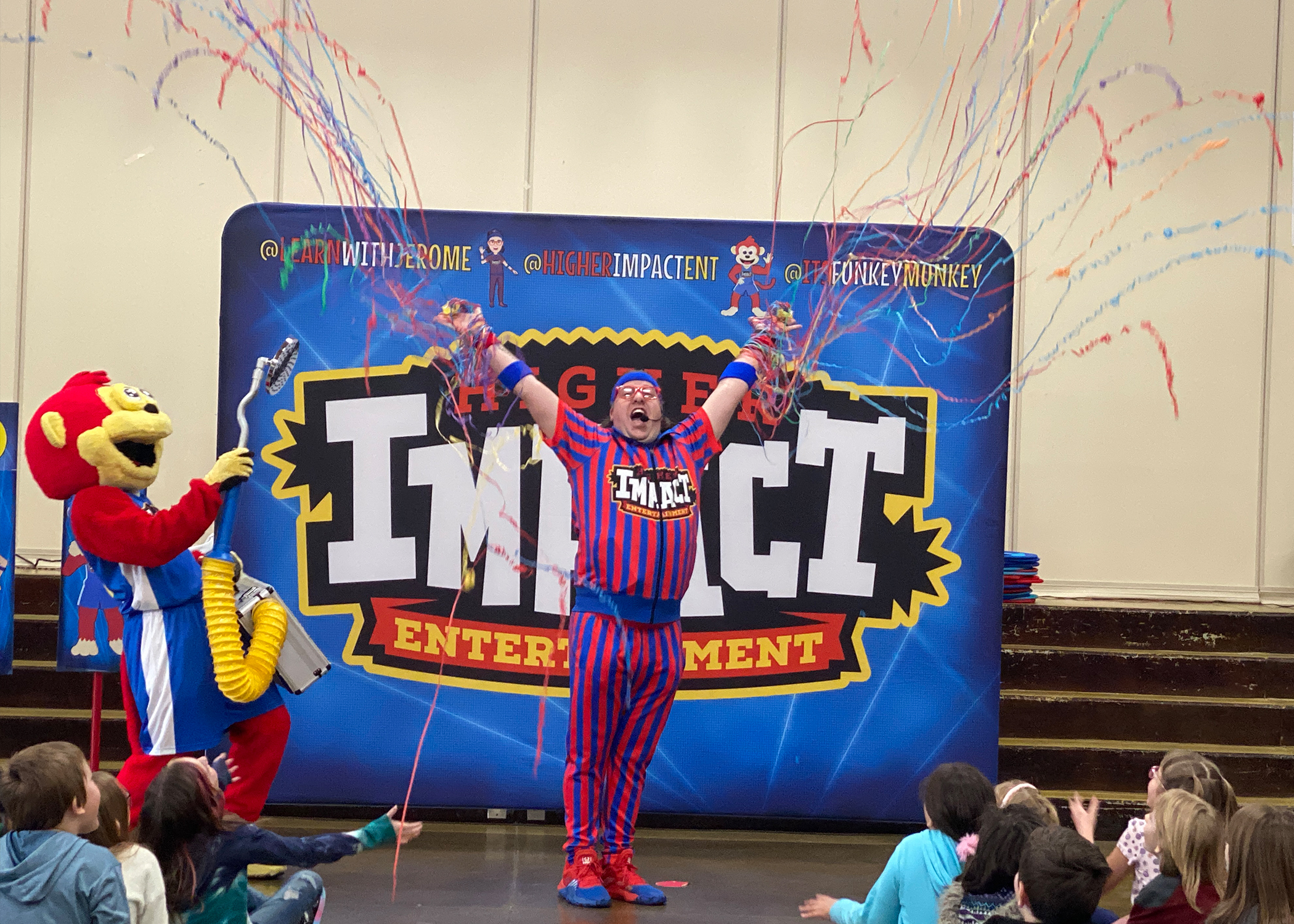 Funkey Munkey Game Show host and mascot celebrating with students during the grand finale<br />
